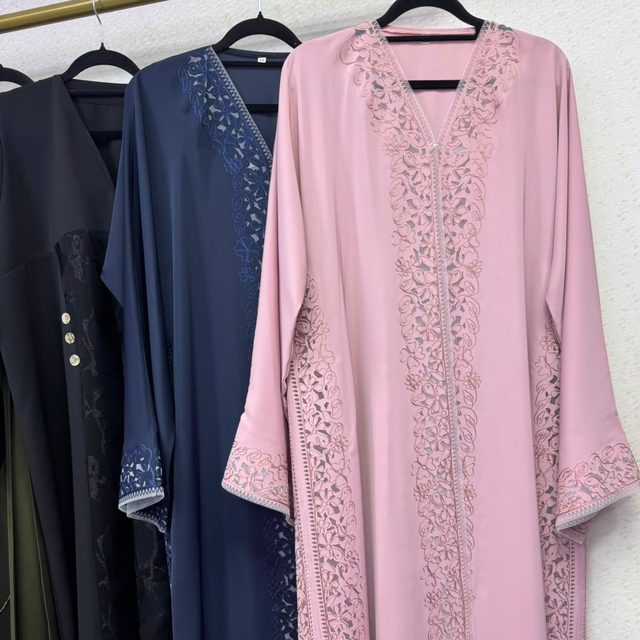 A rail of abayas in pink and navy
