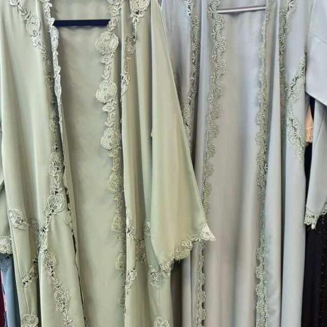 Two sage abayas with tonal lace