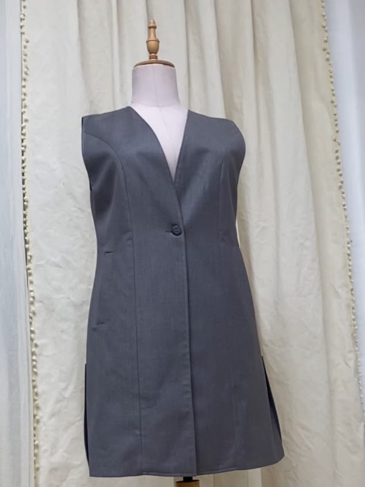 Long grey sleeveless waistcoat with a V neck